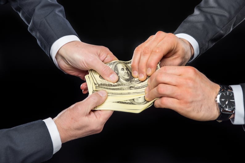 Close-up partial view of businesspeople fighting for money isolated on black