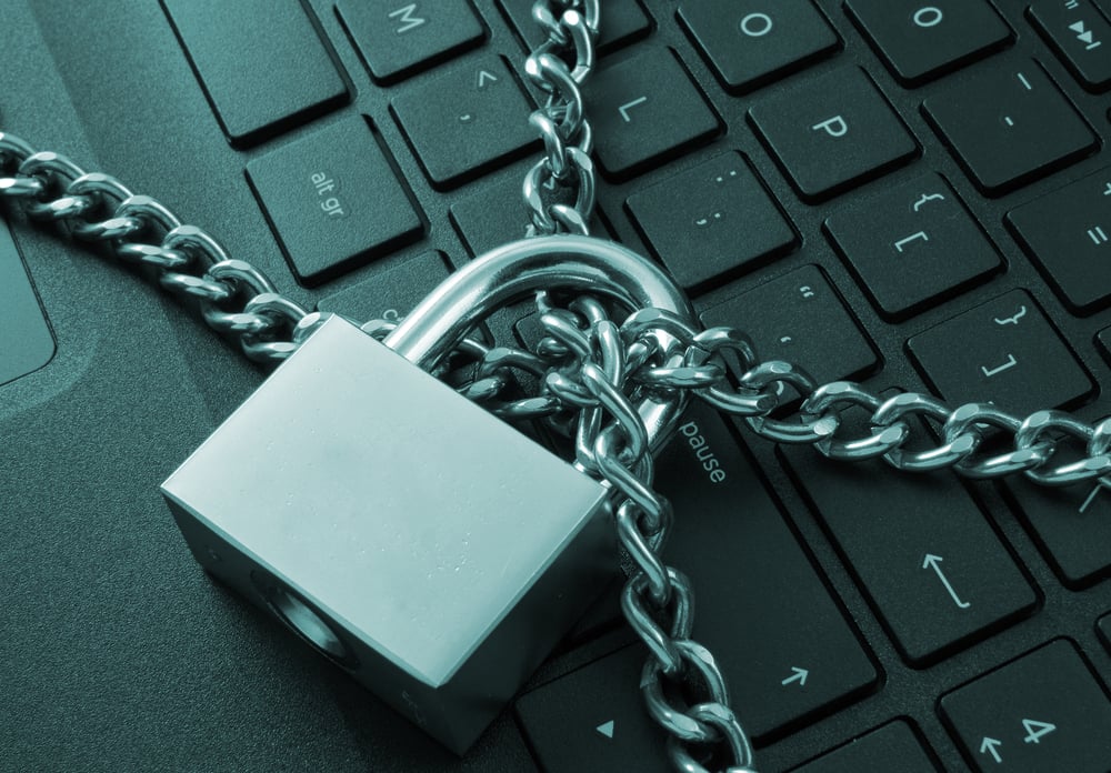 locked chain on laptop keyboard to signify cyber security