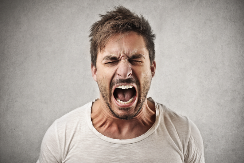 Portrait of young angry man.