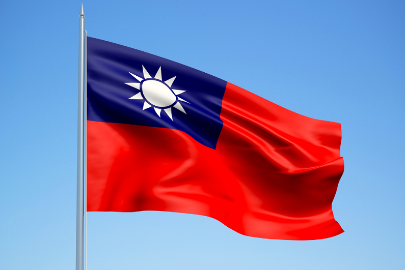 Taiwan flag against clear blue sky.