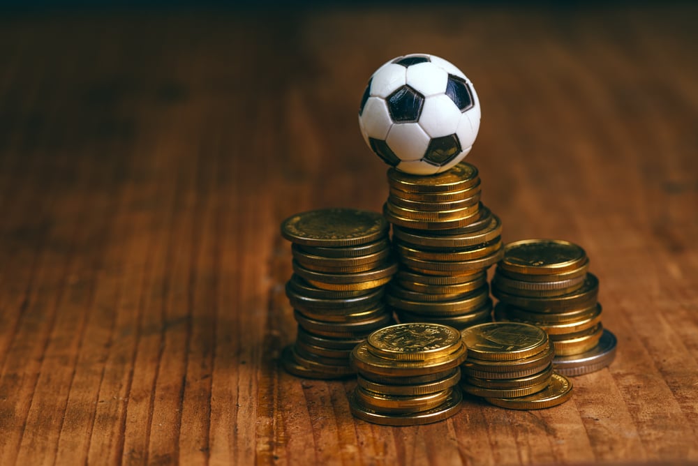 stacks of coins and miniature football