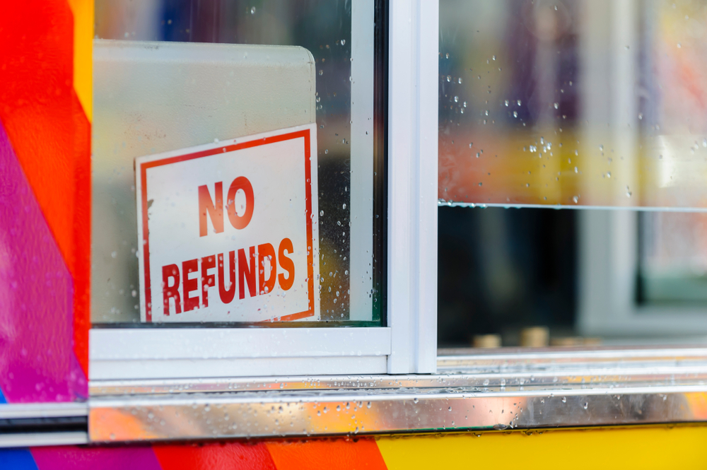 office booth window sign reading no refunds