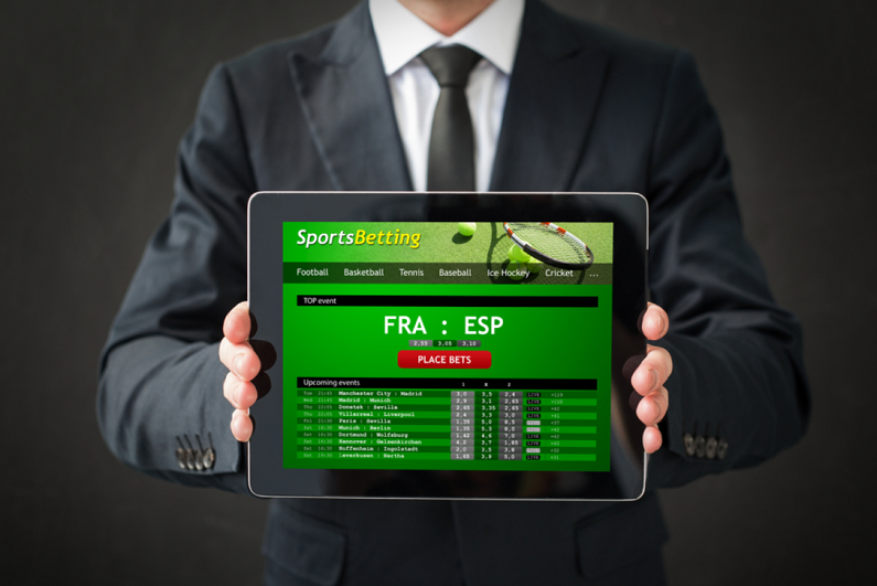 businessman showing sports betting website on tablet