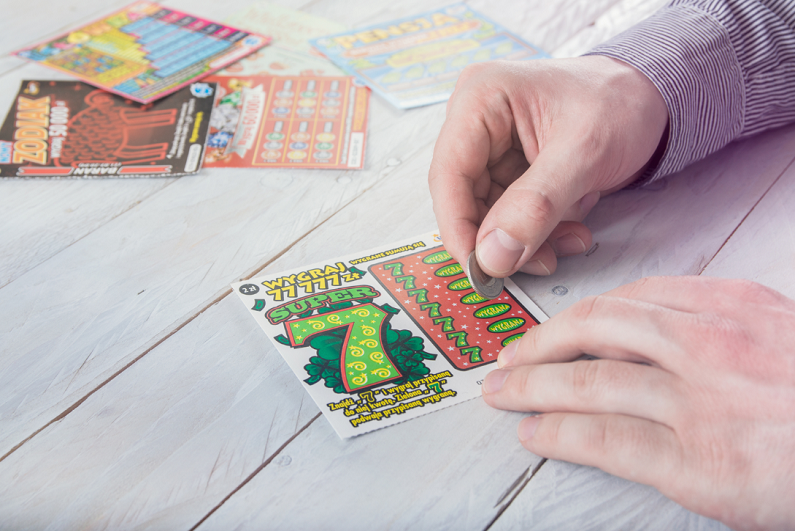 man scratching a lottery ticket