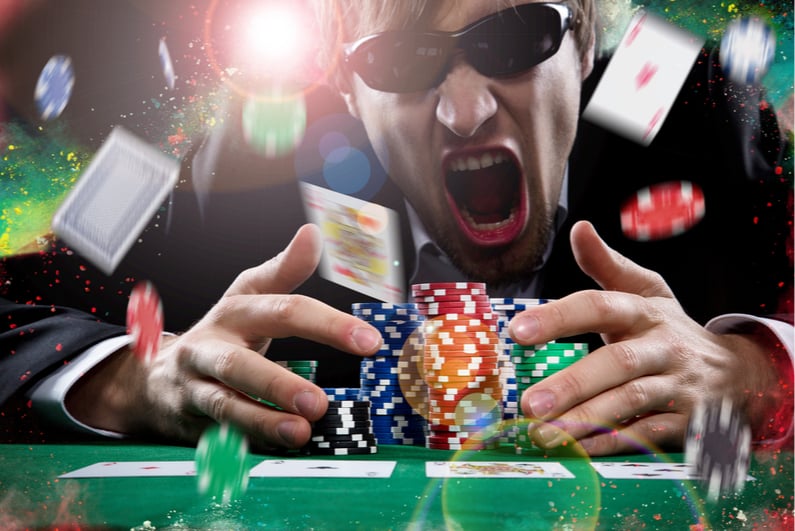 Excited man winning a big poker pot