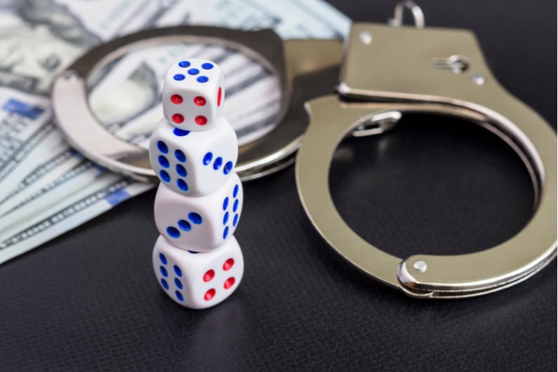 handcuffs, cash, and dice