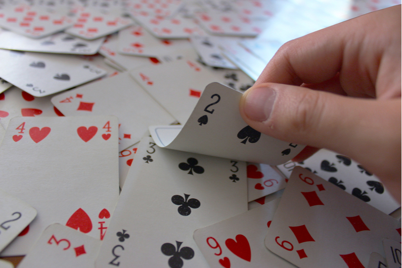 Showing 2 of clubs on top of a mess of face-up cards